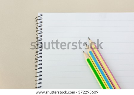 3 color pencils on notepad