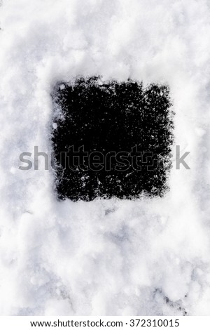 Black background round shape in the snow. Perfect window frame for any picture, just replace black color with your image in photo editor, by layered over it in screen mode.