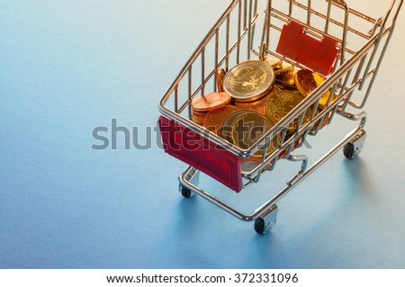 A shopping cart with euro coins, symbolic photo for purchasing power and consumption