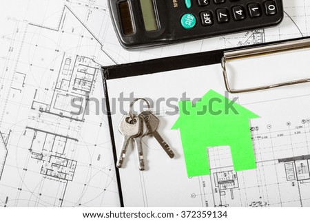 Model house on construction plan for house building with keys . Real Estate Concept.