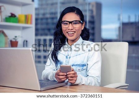 Asian woman using smartphone in office