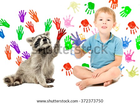 Cute boy with raccoon sitting  on the background of handprints