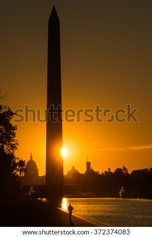 Washington D.C. - Sunrise at Lincoln Memorial with  silhouettes of Capitol Building and Washington Monument
