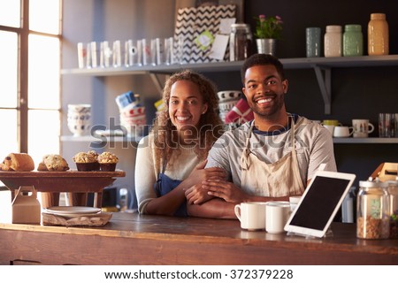Portrait Of Couple Running Coffee Shop Behind Counter Royalty-Free Stock Photo #372379228
