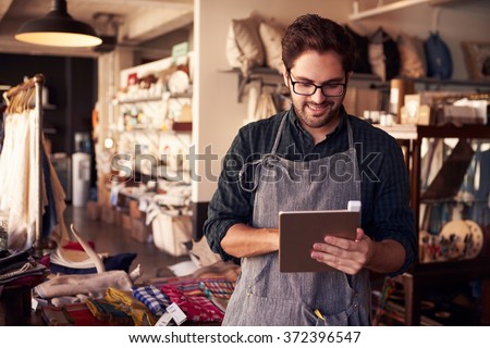 Male Owner Of Gift Store With Digital Tablet Royalty-Free Stock Photo #372396547