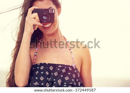 Close up Portrait of beautiful  woman with retro hipster camera 