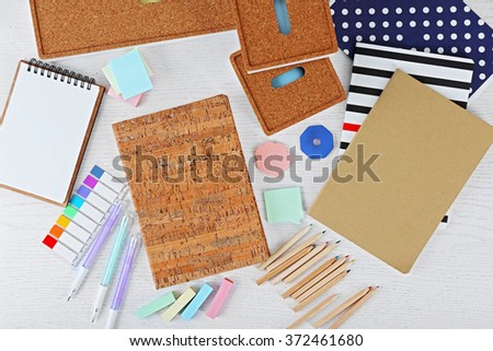 Notebooks with stationery on a white table