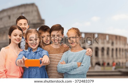 children talking smartphone selfie over coliseum