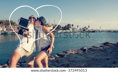 Young couple take their kissing self photo 