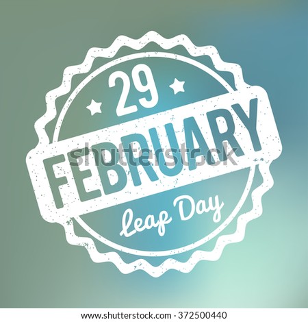 29 February Leap Day rubber stamp white on a blue bokeh fog background. Royalty-Free Stock Photo #372500440
