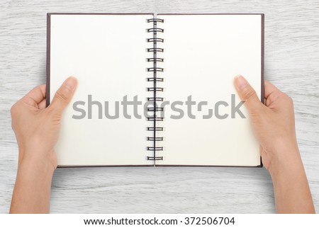 A woman two hands open a empty book mockup with clipping path