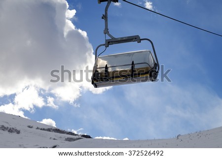 Chair-lift in ski resort at sun evening. Greater Caucasus, Mount Shahdagh. Qusar rayon of Azerbaijan.