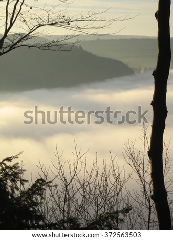 Photo taken at Offa's Dyke on Wales border above a thick blanket of fog which had persisted all day Above the fog the late afternoon Autumn sunshine illuminated the contours in the fog blanket 