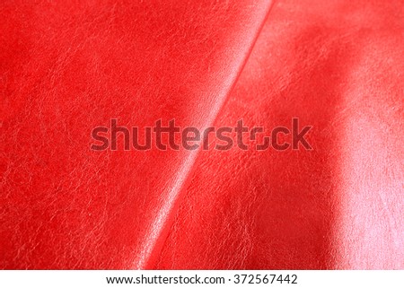 Red shiny leather texture close up
