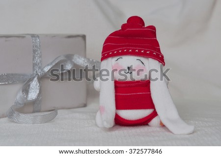 Handmade white rabbit in red hat
