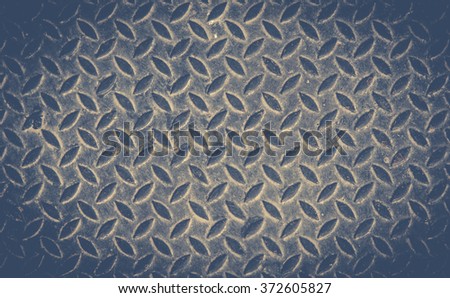 texture background of grungy old weathered  metal diamond plate with scratch and dirty in dark tone