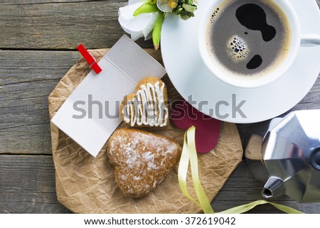Heart shaped cookies (big and small as couple), cup of coffee, bouquet of flowers decoration. sunny morning.Steam (geyser) coffee maker. Romantic breakfast or Valentine's Day Breakfast. Toned image