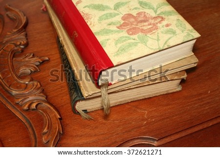 three closed old books on wooden background