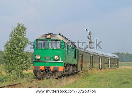 Passenger train passing through polish countryside