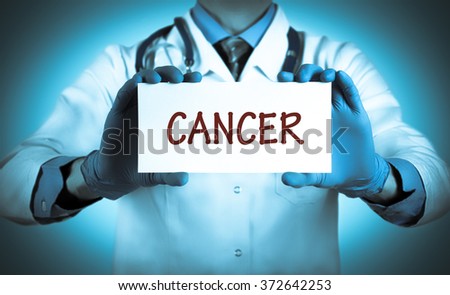 Doctor keeps a card with the name of the diagnosis -?? cancer. Selective focus. Medical concept.