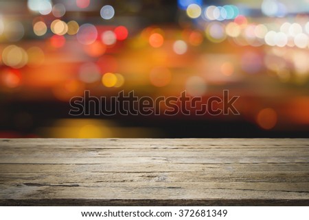 Empty wooden table platform and bokeh at night for product display montage.