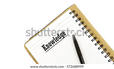 White note book with text KNOWLEDGE isolated on white background