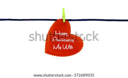 Single red love shape with text HAPPY ANNIVERSARY MY WIFE clipped on blue rope isolated on white background