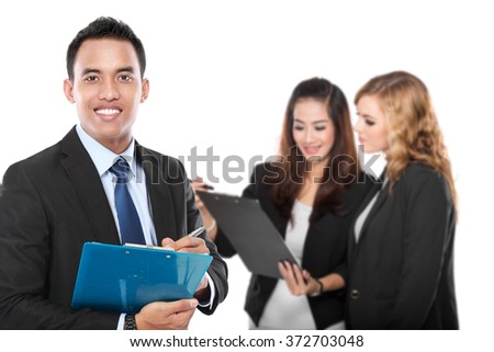 A portrait of a young asian businessman, with his team behind. isolated in white background