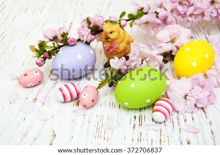 Easter eggs and cherries blossom on a old wooden background