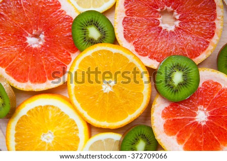 Citrus fruit background with a group of oranges lemons lime tangerines and grapefruit as a symbol of healthy eating and immune system boost with natural vitamins.