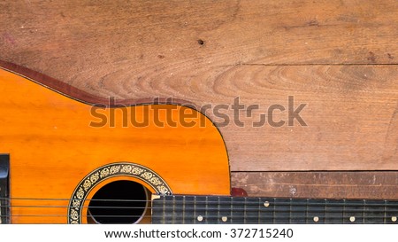 Top view workspace with acoustic guitar on wooden table background .Free space for your text.