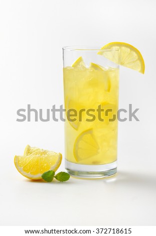 glass of fresh lemon juice with ice on white background
