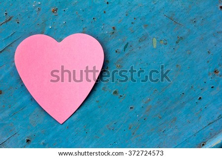 Valentine - paper pink heart against a blue painted surface. Copy space. Free space for text, Close-up, top view
