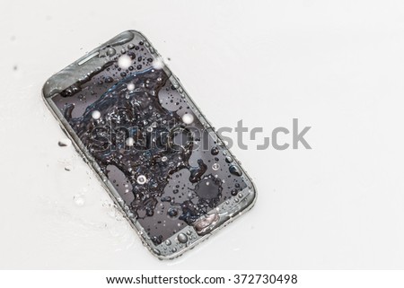 Black smartphone destroyed with rain, water, droplets