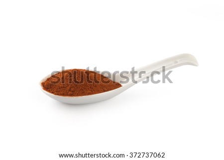 Finely ground smokey paprika on a  white spoon isolated on white background.