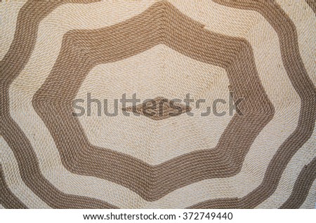 Background image of a hand-woven carpet with ancient ornament.