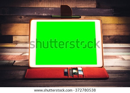 Green screen tablet pc on the wooden background