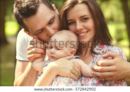parents with baby in park 