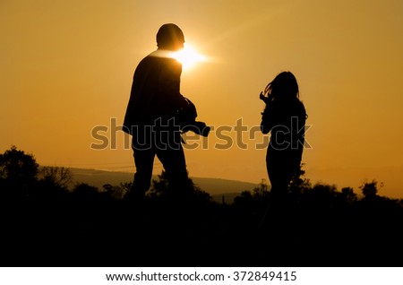 Silhouette of photographer and mannequin at photography outdoor
