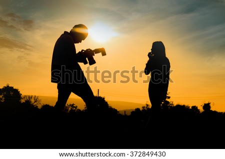 Silhouette of photographer and mannequin at photography outdoor