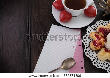 Valentine's day note with a Cup of coffee and dessert. A date in a vintage cafÃ©. Wooden heart on a plate.
