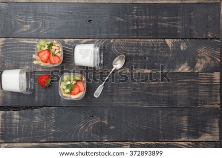 Yogurt with fruits on a rustic table