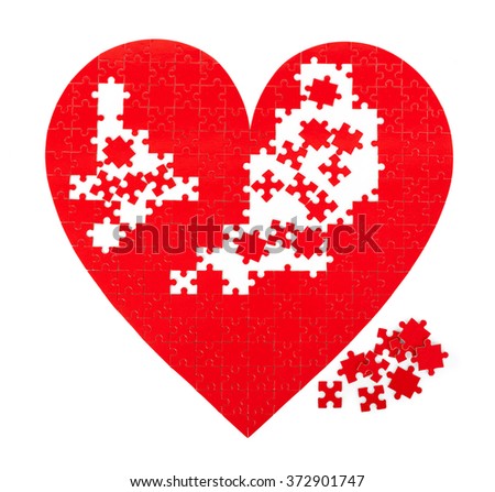 Red puzzle heart shape on white background.