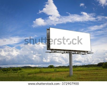 Empty billboard in front of beautiful cloudy sky in a rural location Royalty-Free Stock Photo #372907900