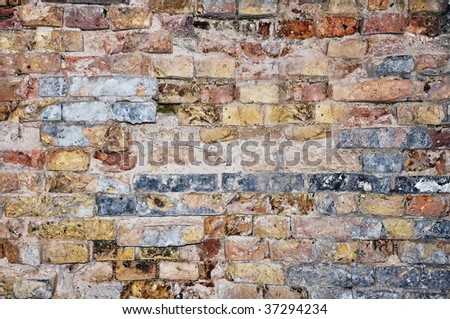 An old and characteristic wall, colorful brick wall