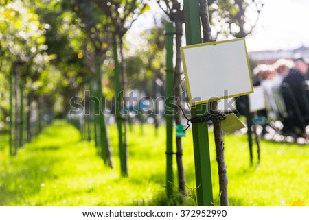 A blank board in Vienna's (Austria) people's park with a rose garden