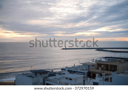 Beautiful landscape of coastal town and seaside resort with lighthouse tower on background