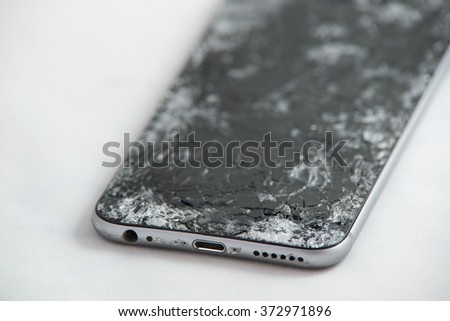 mobile smartphone with broken screen isolated on white background.