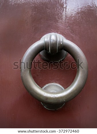 Old rusty gate latch on the wooden door