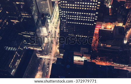Midtown Manhattan New York intersection illuminated by traffic at night